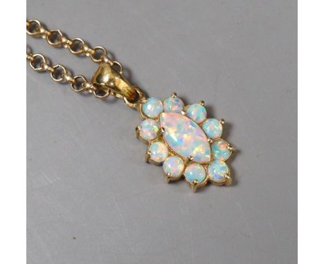 A modern 585 yellow metal and opal set oval cluster pendant, 18mm, on a 9k chain, 50cm, gross weight 9.9 grams.**CONDITION RE