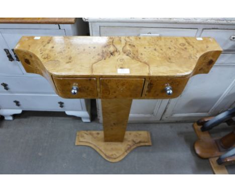 An Art Deco style maple effect three drawer console table 