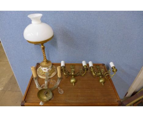 A gilt metal and porcelain table lamp and three wall lights 