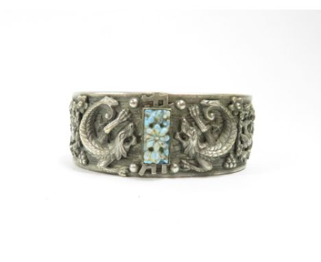 A white metal hinged bangle, decorated in the Chinese export taste, set with a paste simulating turquoise