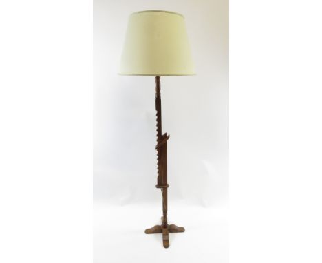 A 1930's oak floor/standard lamp with an adjustable ratchet mechanism
