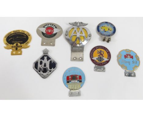 A collection of car bumper badges including Morgan Sports Car Club Scotland; Bath Mog 97, Mog 93; Morgan Muster 2001; AA; RAC