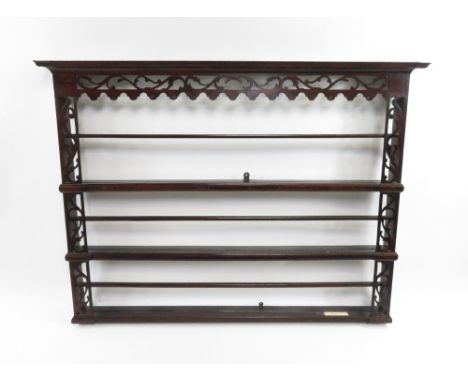 An 18th century oak hanging shelf, with stylised fretwork border, 103cm high, 135cm long, 14cm deep
