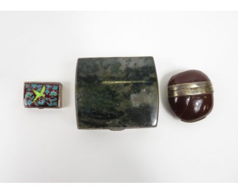 A white metal mounted coquilla nut, along with a moss agate box and a small enamelled snuff box