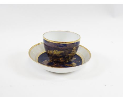 A Spode cup and saucer having gilt decoration of a rural landscape with watermill on deep blue ground