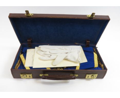 A Masonic apron and sash for Hertfordshire, along with three gilt metal medals, gloves and various paperwork contained in a l