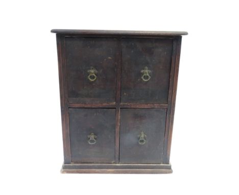 A 20th century four drawer table top cabinet, with four brass swing handles, 56cm high, 46cm square