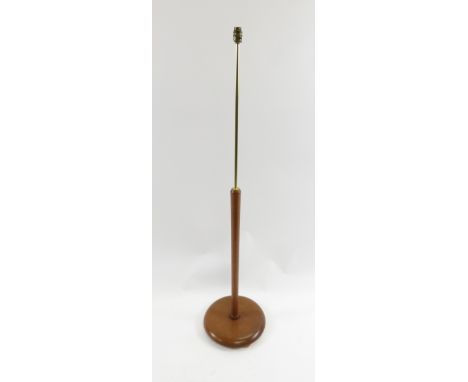 A mid century vintage teak standard lamp, with circular base and brass stem
