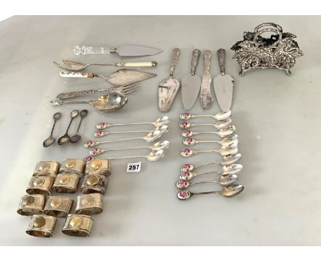 Assorted plated cutlery comprising 14 assorted size enamel handled spoons, 3 spoons without enamel tops, 6 cake servers, 2 fo