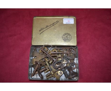 A tin of clock and watch winding keys