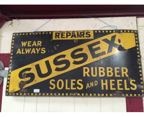 A "Sussex Rubber Soles and Heels" enamel sign, 36" x 18" approx. 