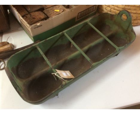 A small iron feeding trough with divisions