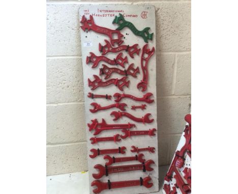 A display board featuring a quantity of spanners from the International Harvester Co. including Titan 1917 spanner (20)