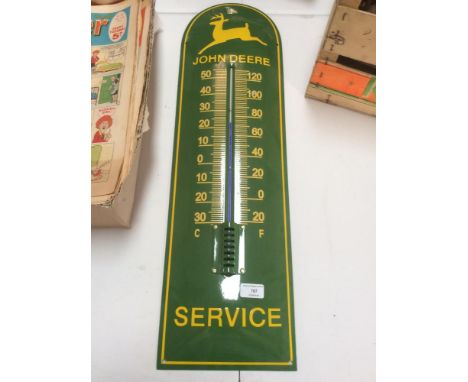 A large John Deere enamel thermometer