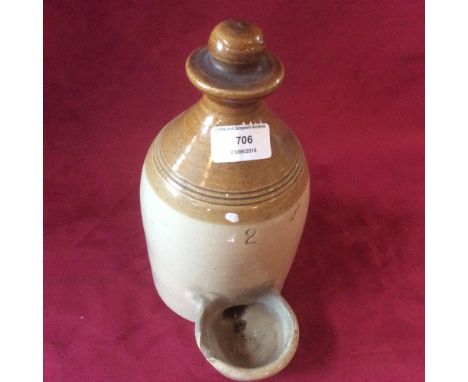 A ceramic poultry drinker