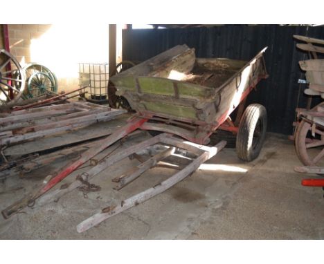 A rubber tyred tumbrel for restoration with extra shafts, tractor draw bar, hay ladders and spare wheel, bearing the name H J