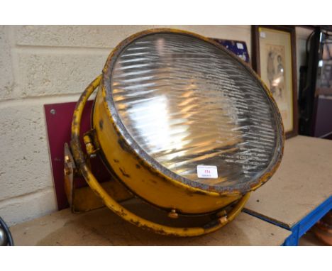 A large yellow enamel floor light