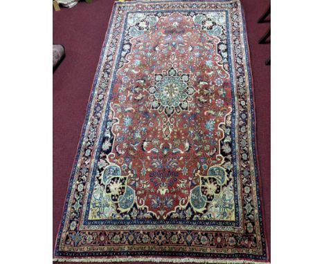 A Northwest Persian Bidjar carpet with central double pendant medallion with repeating petal motifs with four corner medallio