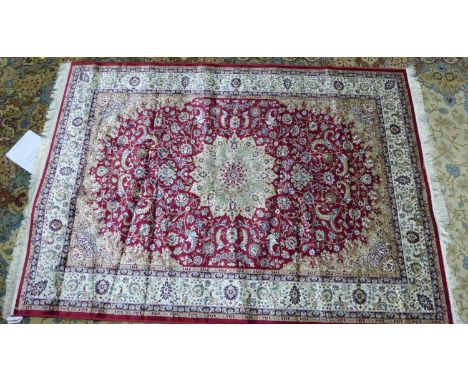 A Keshan style carpet, central floral medallion on a red ground, within floral border, 230 x 160cm 