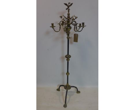 A floor standing brass five branch candelabra, with bird finial, raised on knopped stem and tripod support with claw feet, H.