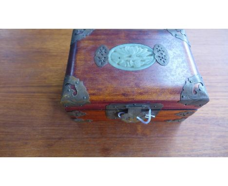 A 20th century Chinese jewellery box with carved jade panel inlay and brass mounts, 8 x 17 x 12cm 