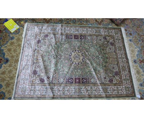 A Keshan style carpet, central floral medallion on a green ground, within floral border, 230 x 160cm 