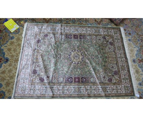 A Keshan style carpet, central floral medallion on a green ground, within floral border, 230 x 160cm 