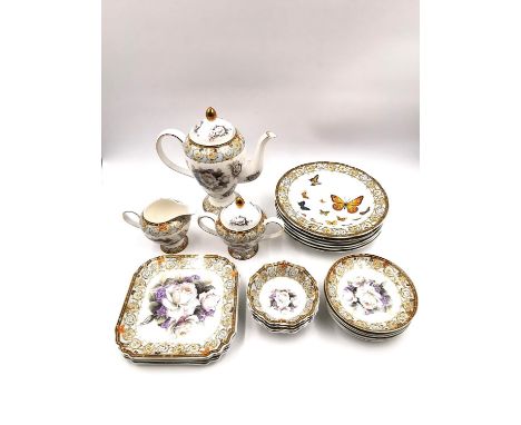 A matched part tea service to include six saucers, six square plates, a teapot, creamer and sugar pot, and six soup bowls, wi