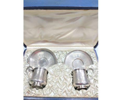 A pair of Continental Silver Cups and saucers. engine turned decoration. marked to base. 219 grams. (fitted case) 