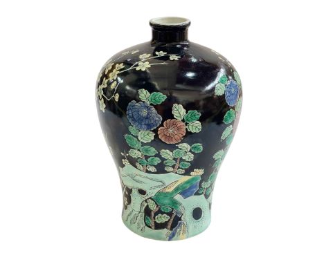 Large Chinese vase decorated with birds and floral design on black ground, Kangxi mark to base, 29cm.