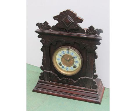 An oak cased Amercian Ansonia Clock Co. mantel clock, painted Roman chapter ring, 8 day movement, key and pendulum, 42.5cm hi