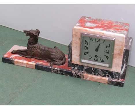 An Art Deco French marble mantel clock surmounted by a cast recumbent dog, Arabic silvered dial, 8 day movement, 19cm high