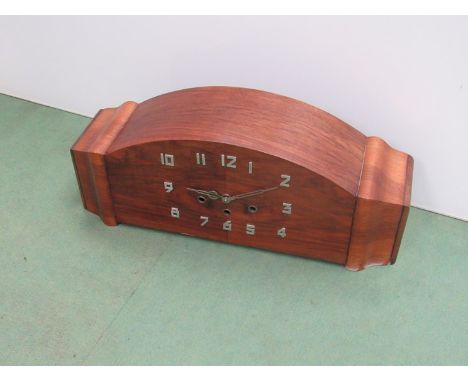 A walnut veneered mantel clock of Deco design with chrome Arabic numerals and hands, three train striking and chiming movemen