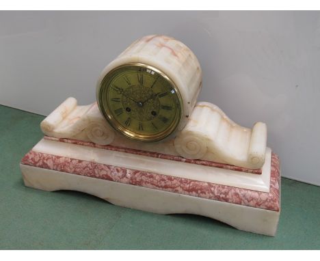 A 19th Century French marble cased mantel clock of scrolled and drum form, brass engraved dial with 8 day striking movement, 
