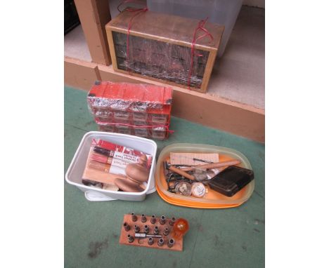 A box containing assorted clock spares and tools including key measuring tool, finials, clamps etc