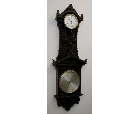 An 8" finely carved dark oak pendant aneroid barometer with eight day clock by Negretti & Zambra, London, no. 5857, circa 188