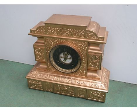 A late 19th Century gold painted cast iron American mantel clock with visible escapement to dial signed W. Duke, Sons & Co, 3