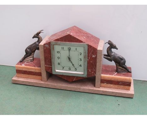 An Art Deco French marble mantel clock surmounted by two cast gazelles, Arabic silvered dial, 8 day movement, 24.5cm high