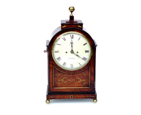 An early 19th Century mahogany bracket clock with brass inlay, bezel, finial, pierced side frets, handles and bun feet, paint