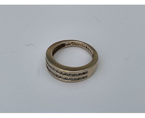 A 9ct gold ring set with 2 channel cut rows of diamonds. 4.6g, N.