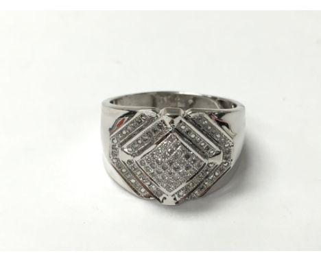 A gents diamond set ring in 10k white gold. The approximate ring size is between T and U.