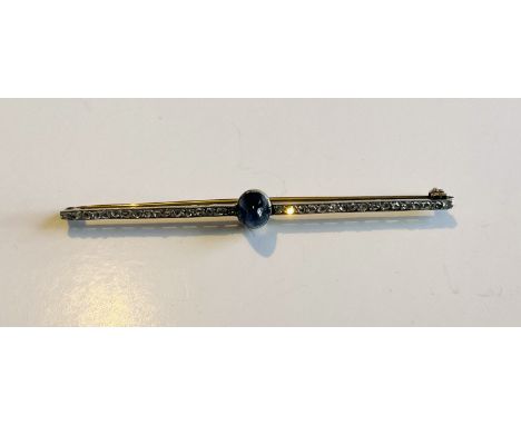 A 1920s design gold bar brooch set with rose cut diamonds and a cabochon sapphire, 7cm.