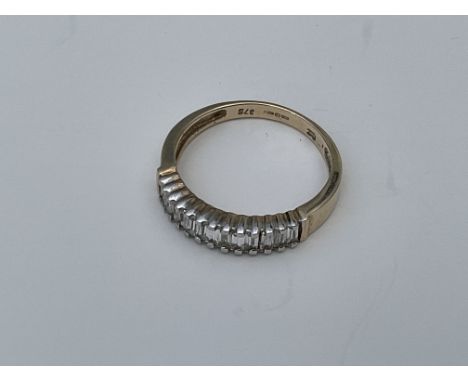 A 9ct gold ring set with a row of CZ baguette cut stones. Approx 2.8g, Q  - NO RESERVE