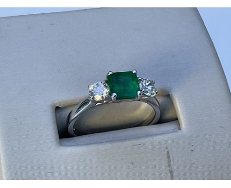 A18ct white gold cushion cut emerald and diamond shoulder ring. M.