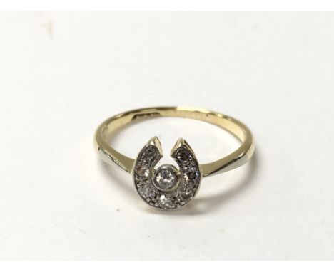 An 18ct diamond set ring in the form of a horse shoe. The approximate ring size is between K and L.