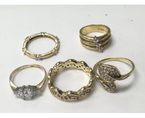 A collection of five rings four silver gilt set with CZ and one unmarked yellow gold (5)