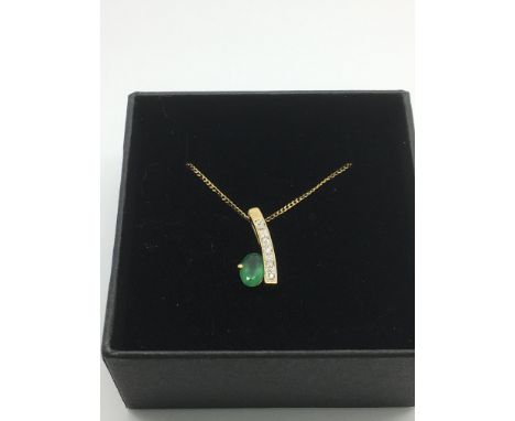 A boxed 9ct gold oval emerald and round cut diamond pendant and chain. Emerald approx 0.45ct, diamonds approx 0.04ct, approx 