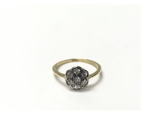 An 18ct ring set with seven diamonds in the formation of a diamond. The approximate ring size is M.