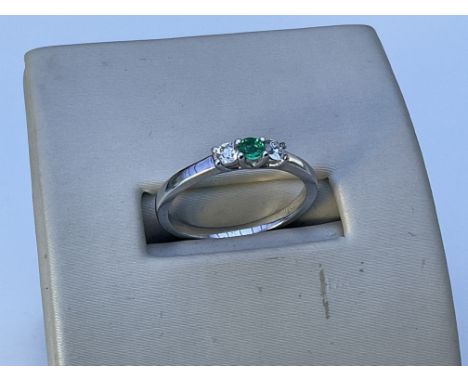 A 14ct white gold emerald and diamond 3 stone ring, O.