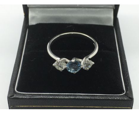 An 18ct white gold ring set with two diamonds and an aquamarine, approx size L-M and approx 3g.